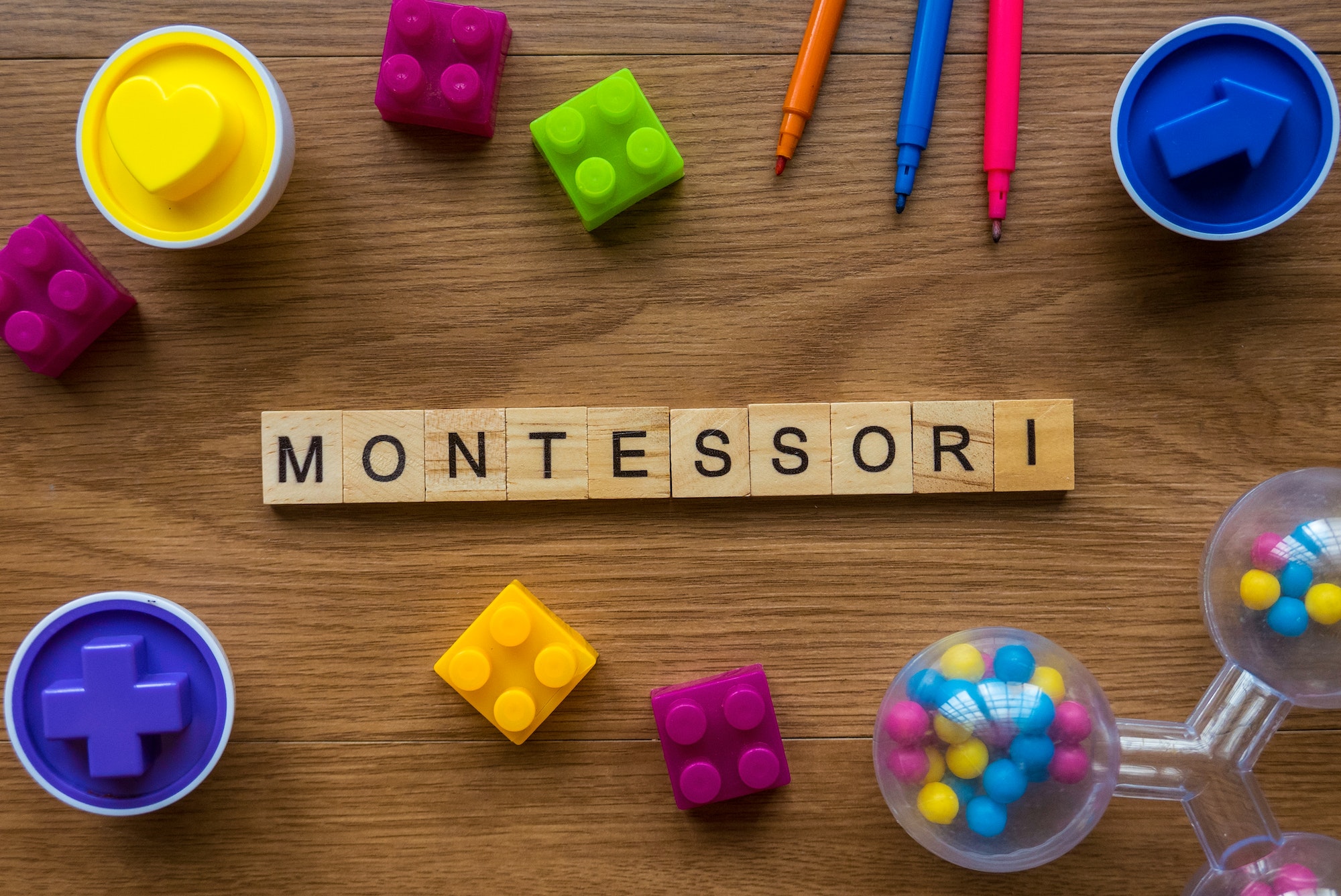 Montessori on wooden alphabet concept with toys on wooden background.